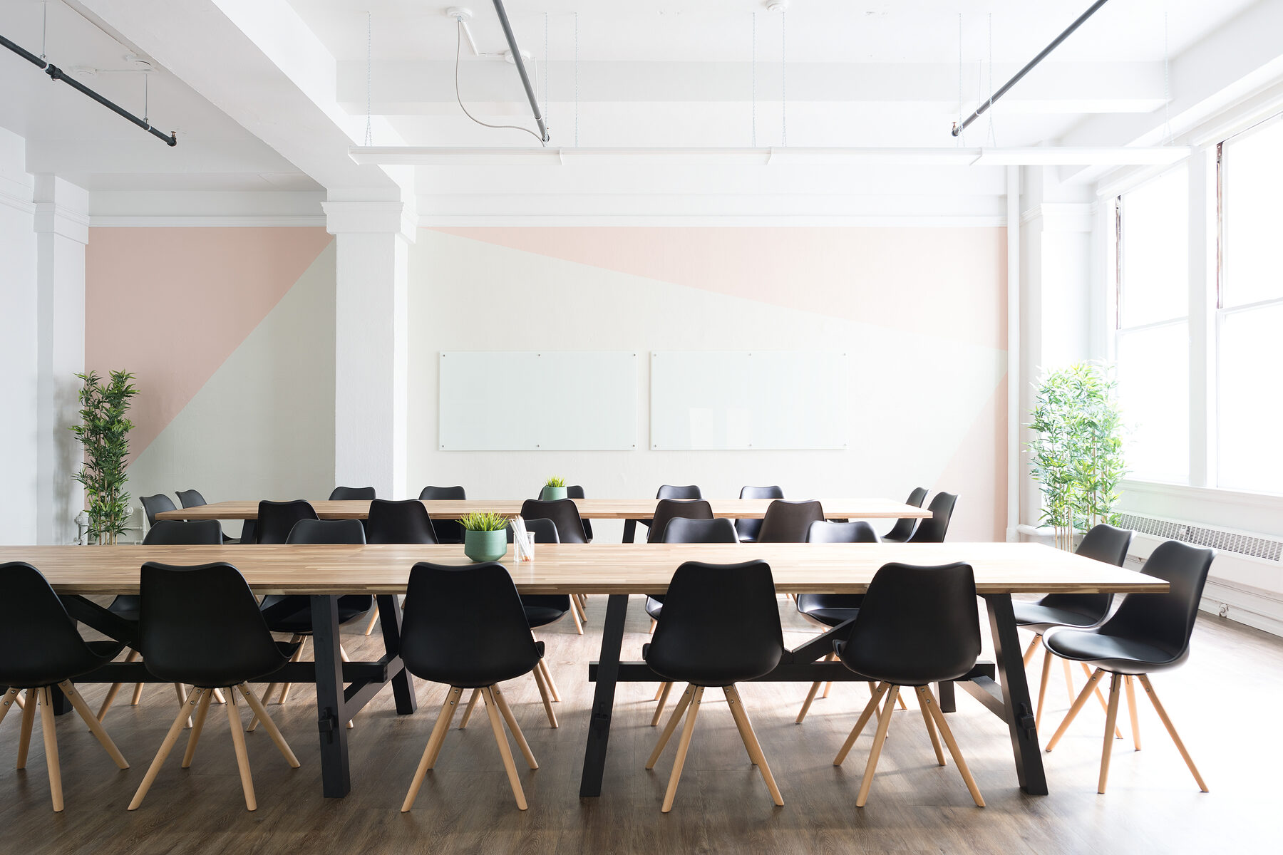 Large meeting room with long tables and chairs